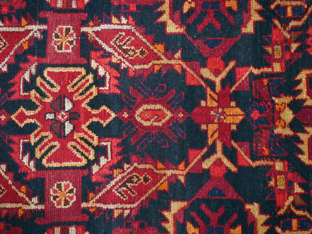 a close up of a red and black oriental rug