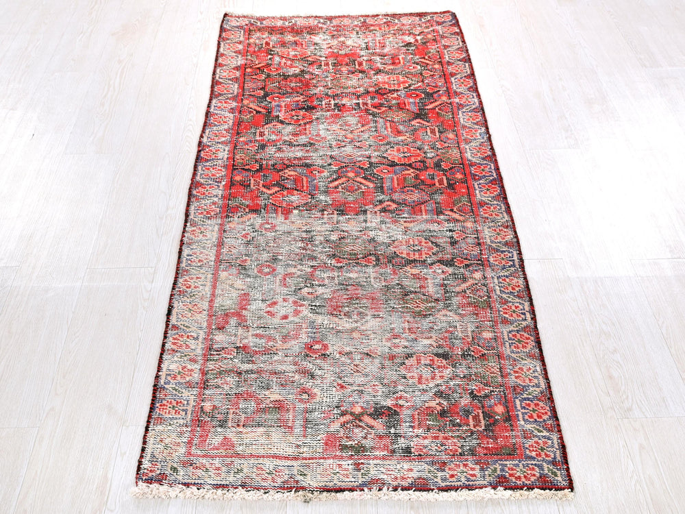 a red rug on a white floor in a room