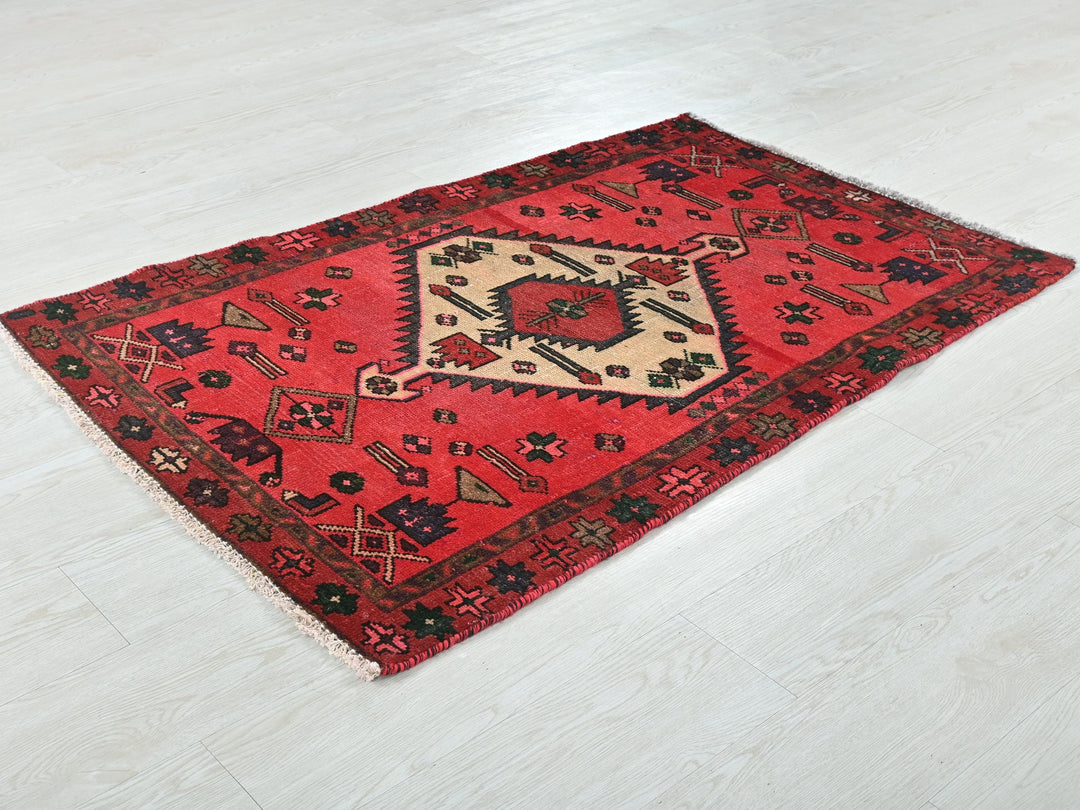 a red rug on a white wooden floor