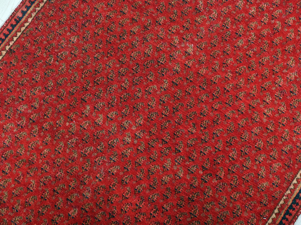 a close up of a red and black rug