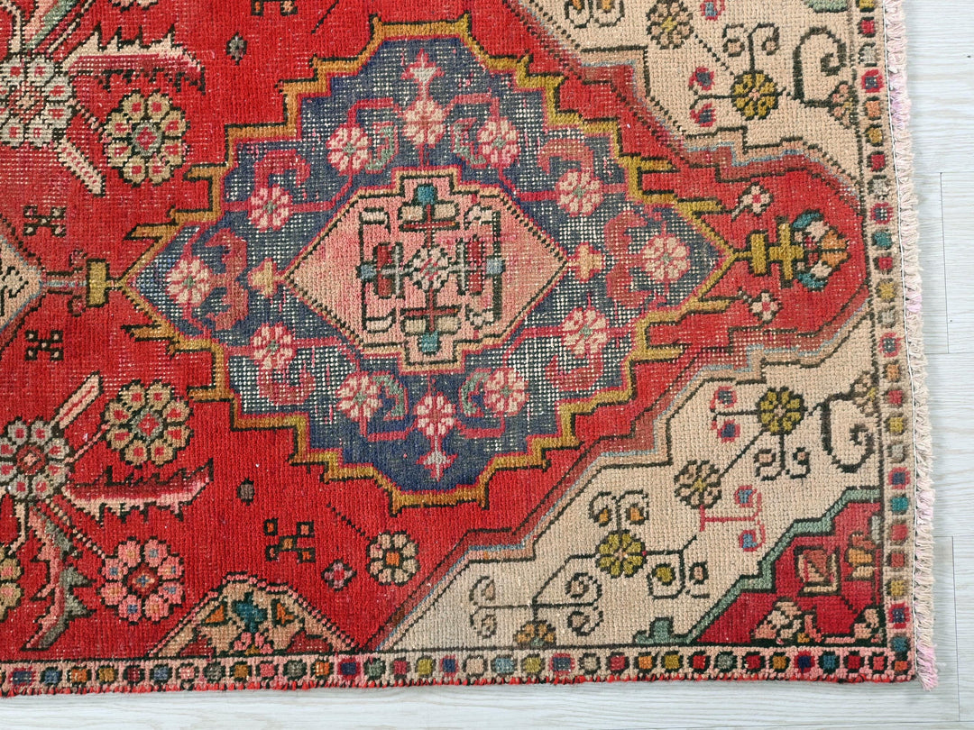 a red rug with a colorful design on it