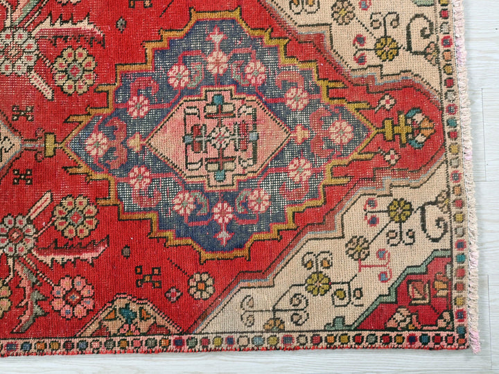 a red rug with a colorful design on it