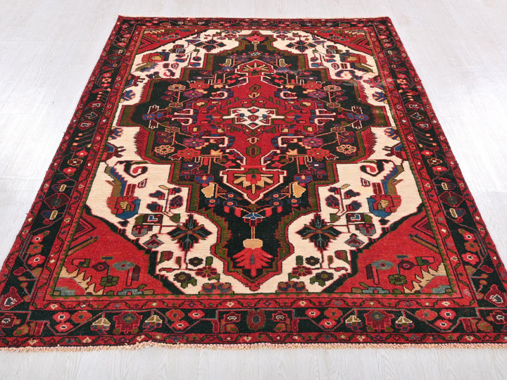 a red and black oriental rug on a white floor