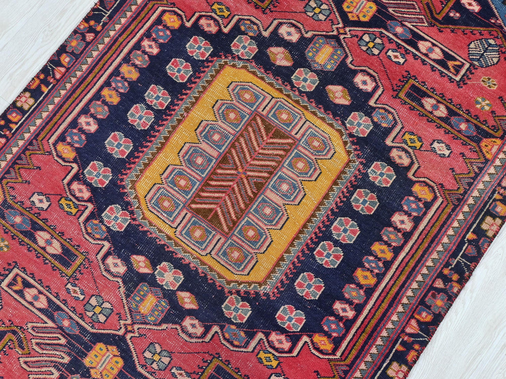 a colorful oriental rug on a wooden floor