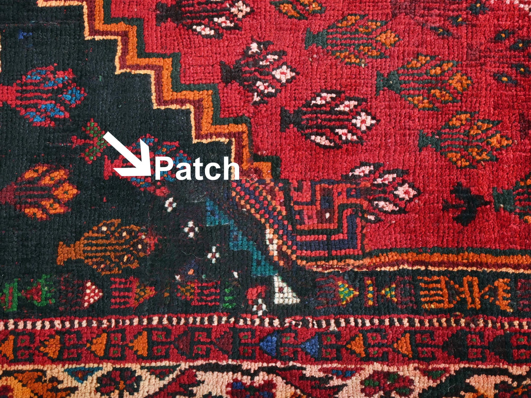 a close up of a red rug with an arrow pointing to it