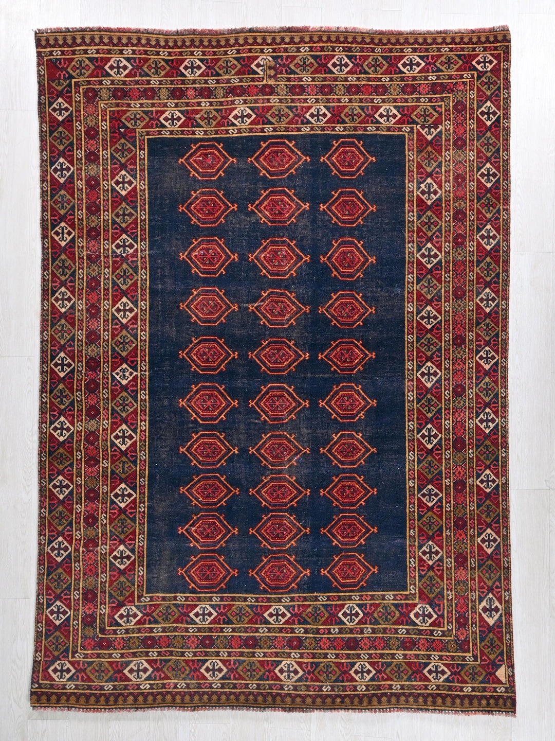 a blue and red rug with a design on it