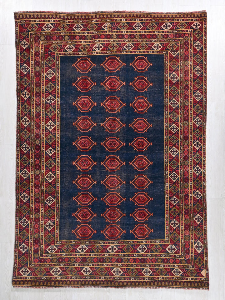 a blue and red rug with a design on it