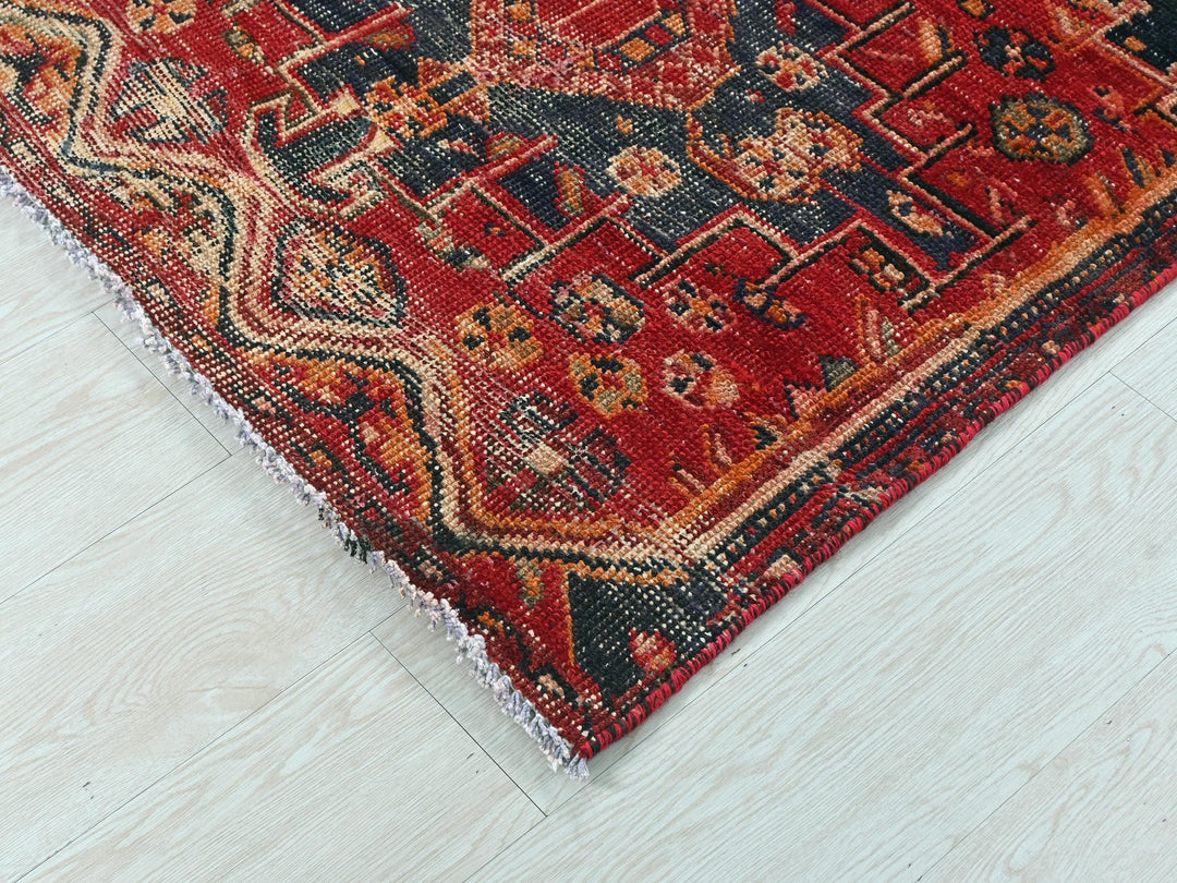 a red rug on a white wooden floor