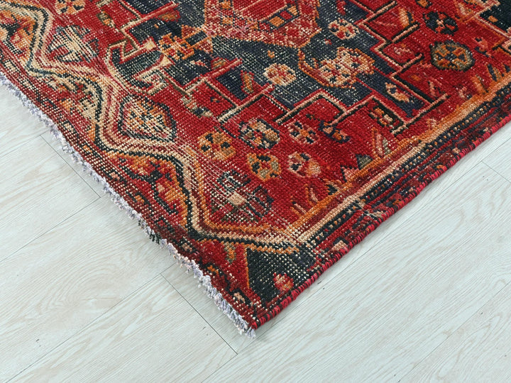 a red rug on a white wooden floor