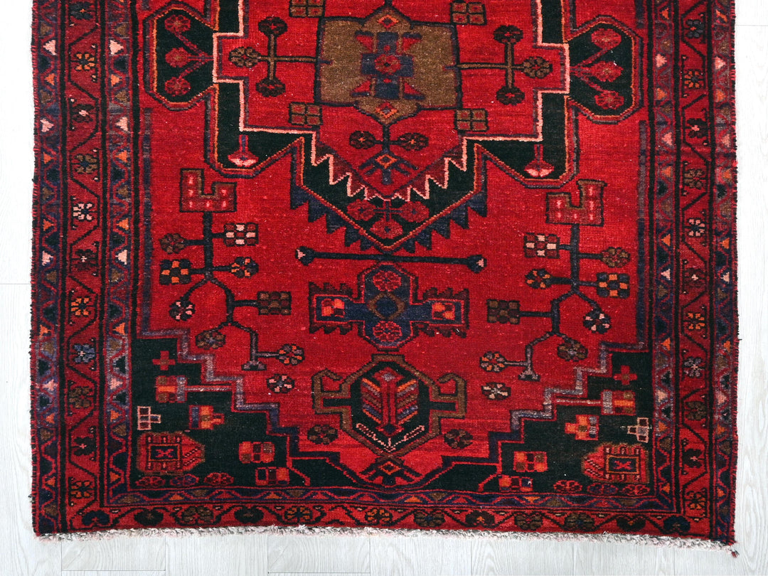 a red rug with a design on it