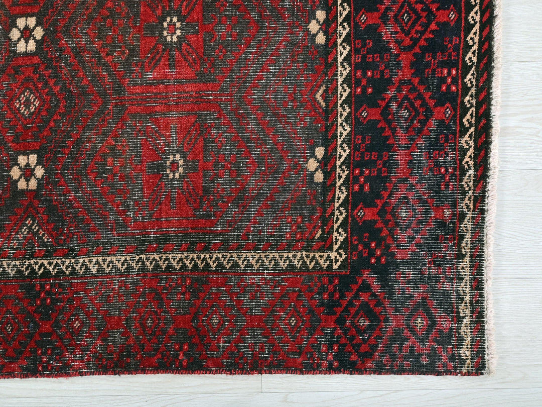 a close up of a red and black rug