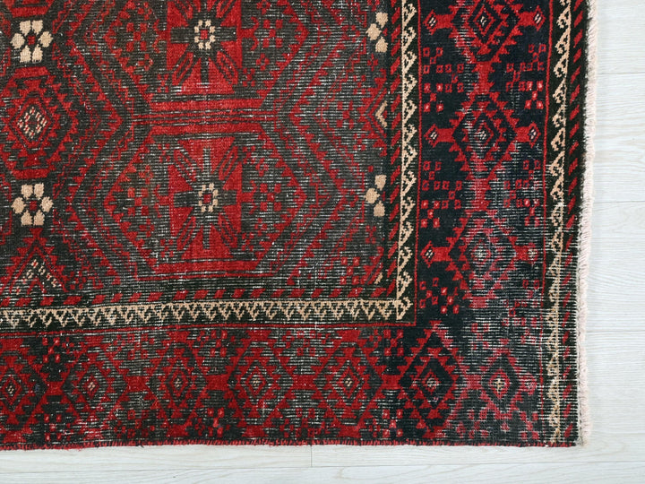 a close up of a red and black rug