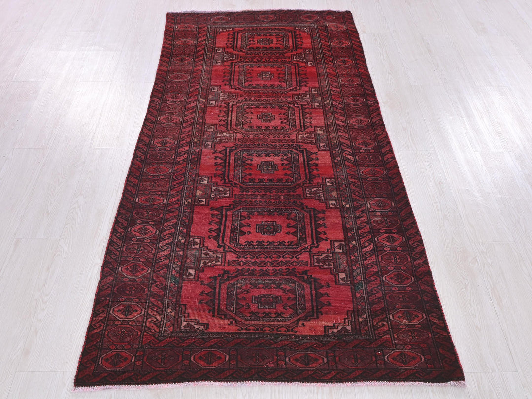 a red rug on a white wooden floor