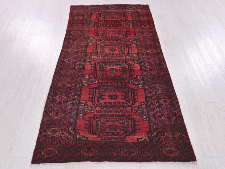 a red rug on a white wooden floor