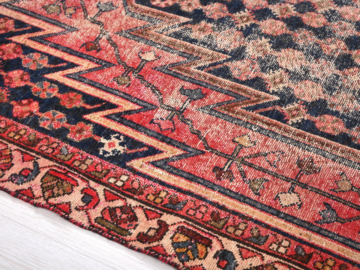 a red rug with a blue and red design on it
