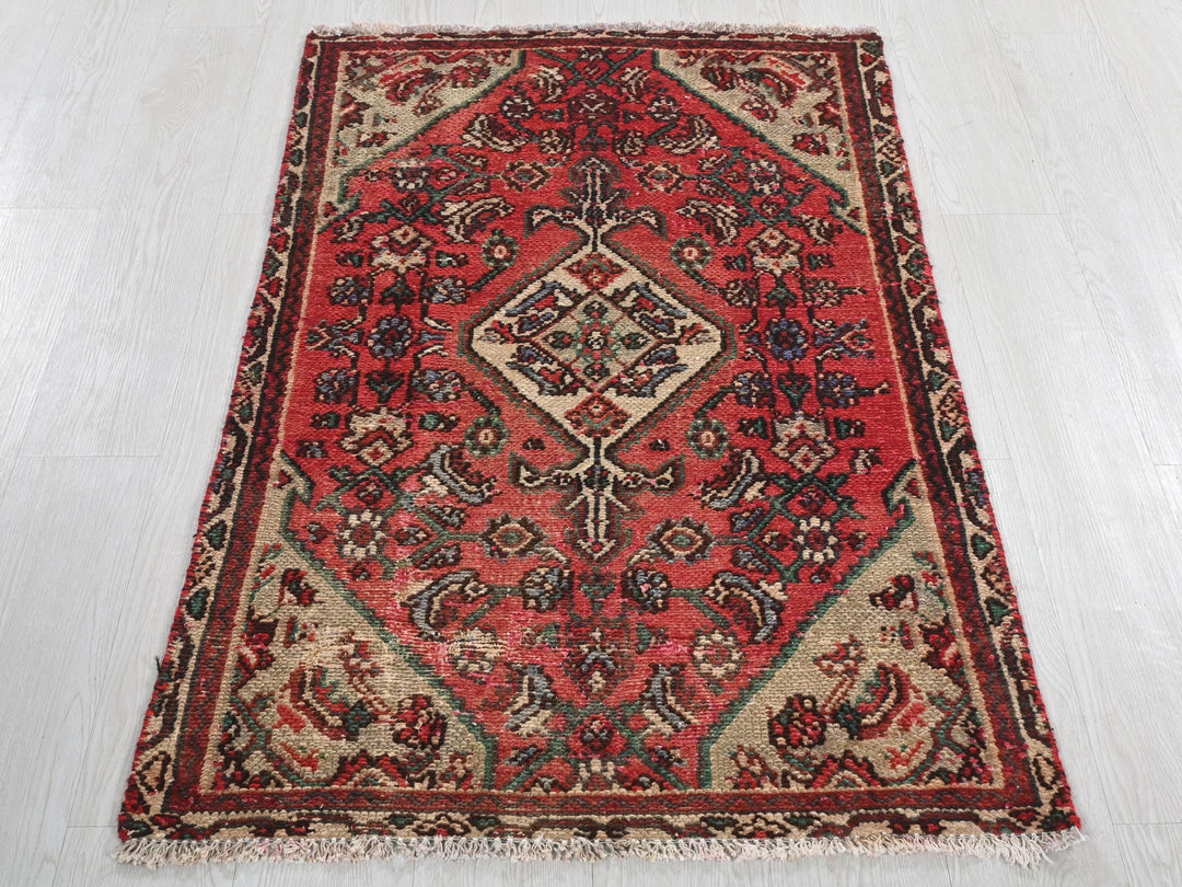 a red rug on a white floor in a room