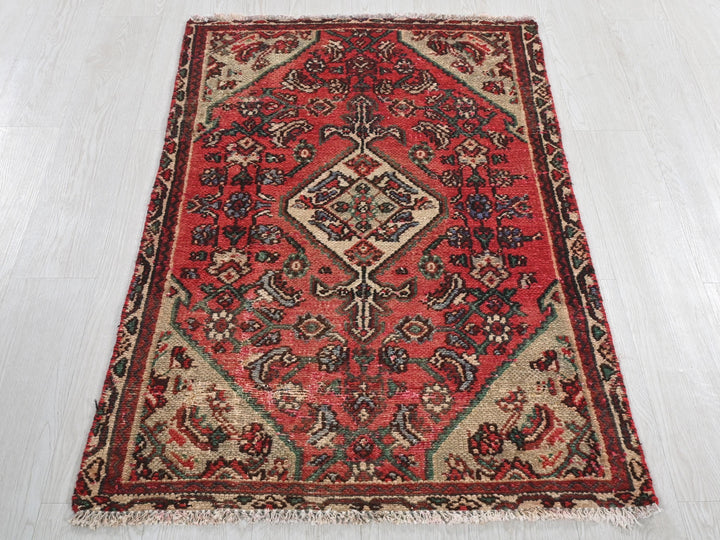a red rug on a white floor in a room