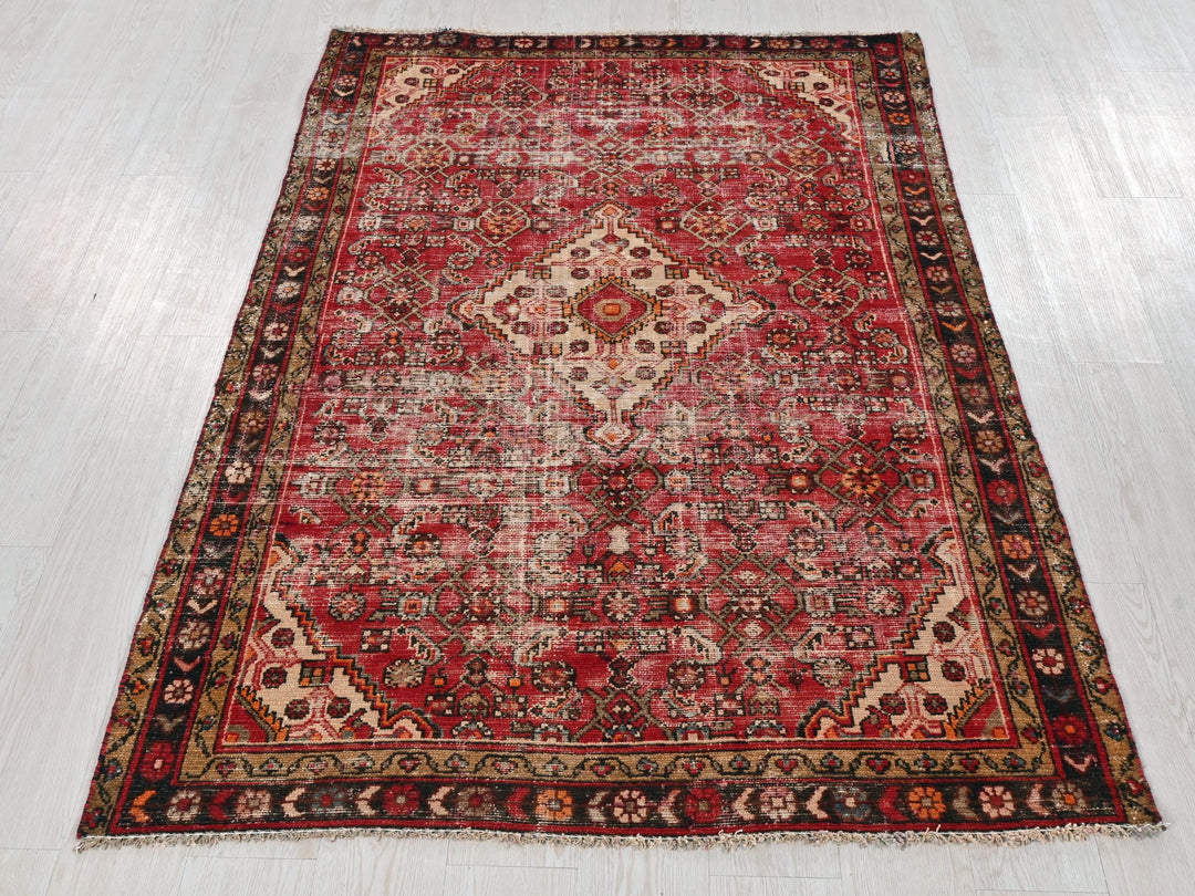 a red rug on a white wooden floor