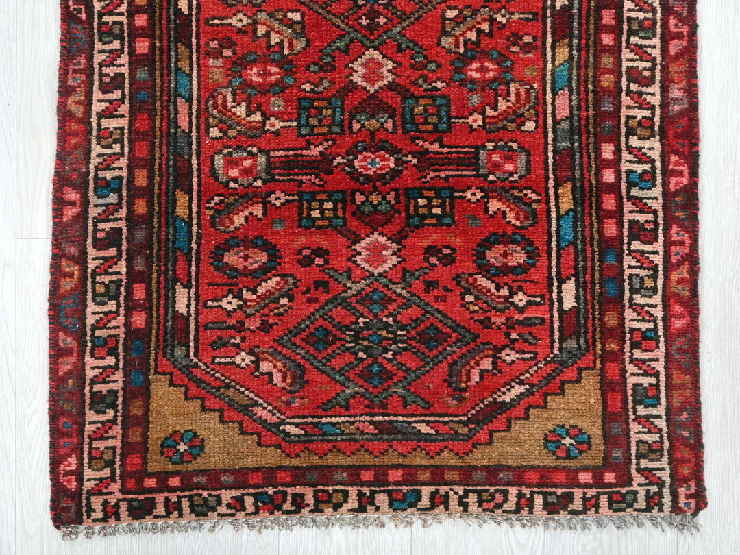 a red rug with a design on it