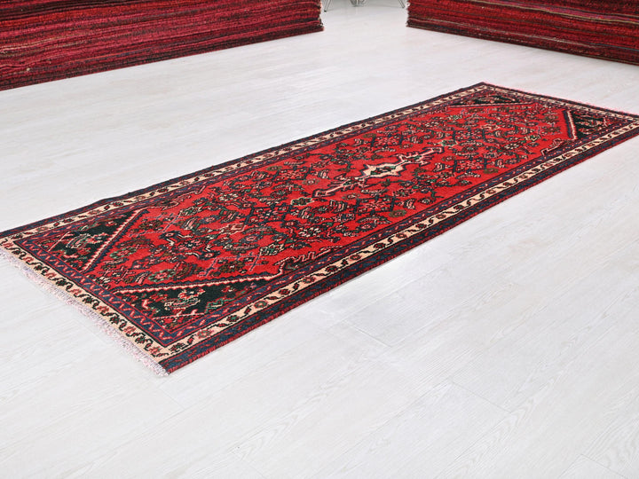 a red rug on the floor of a room