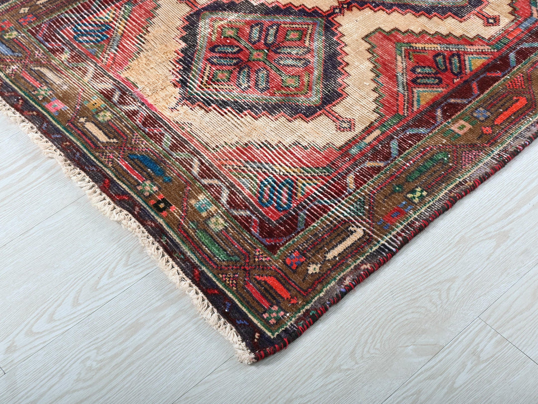 a multicolored oriental rug on a white wooden floor