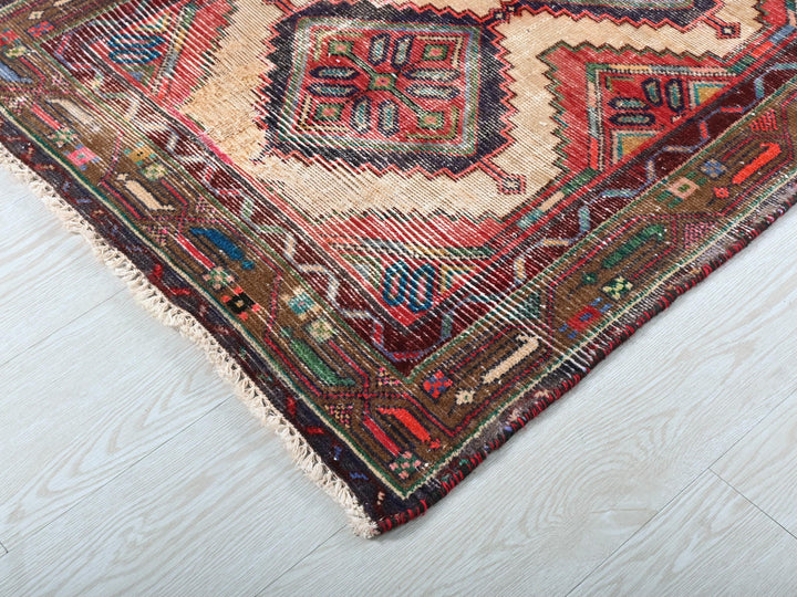 a multicolored oriental rug on a white wooden floor