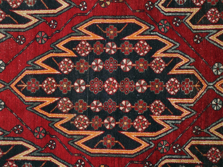 a close up of a red and black oriental rug