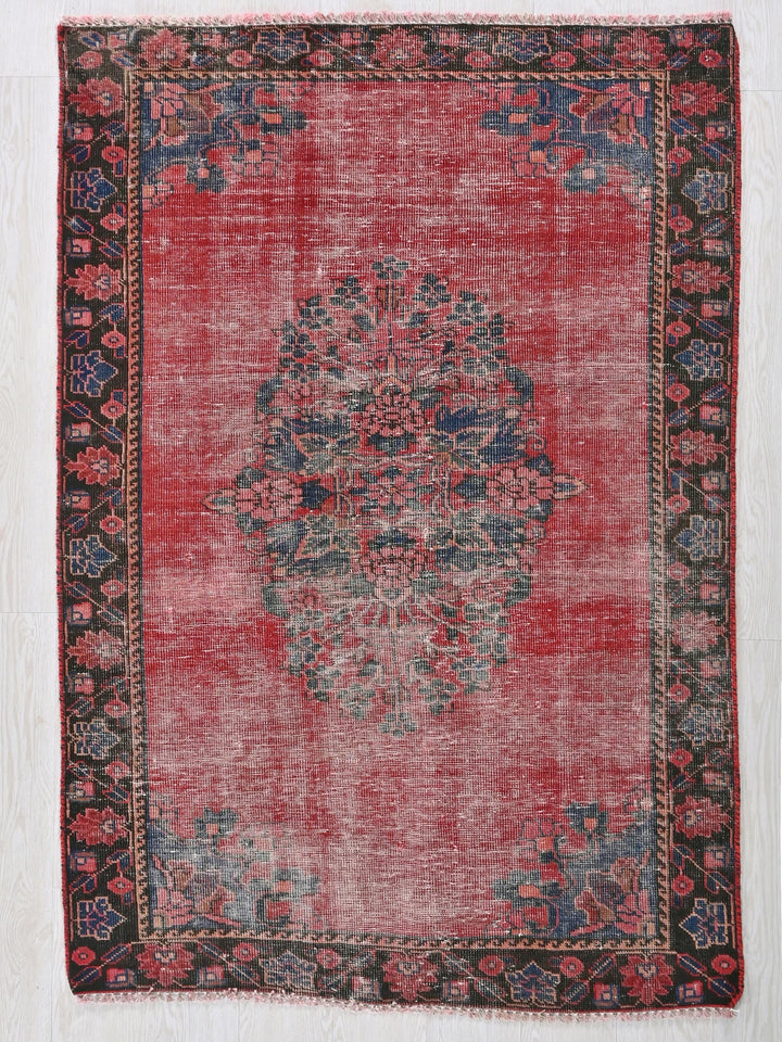 a red rug with a black border on a white background
