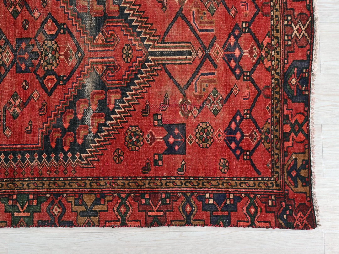 a red rug with a pattern on it