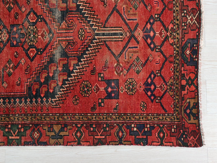 a red rug with a pattern on it