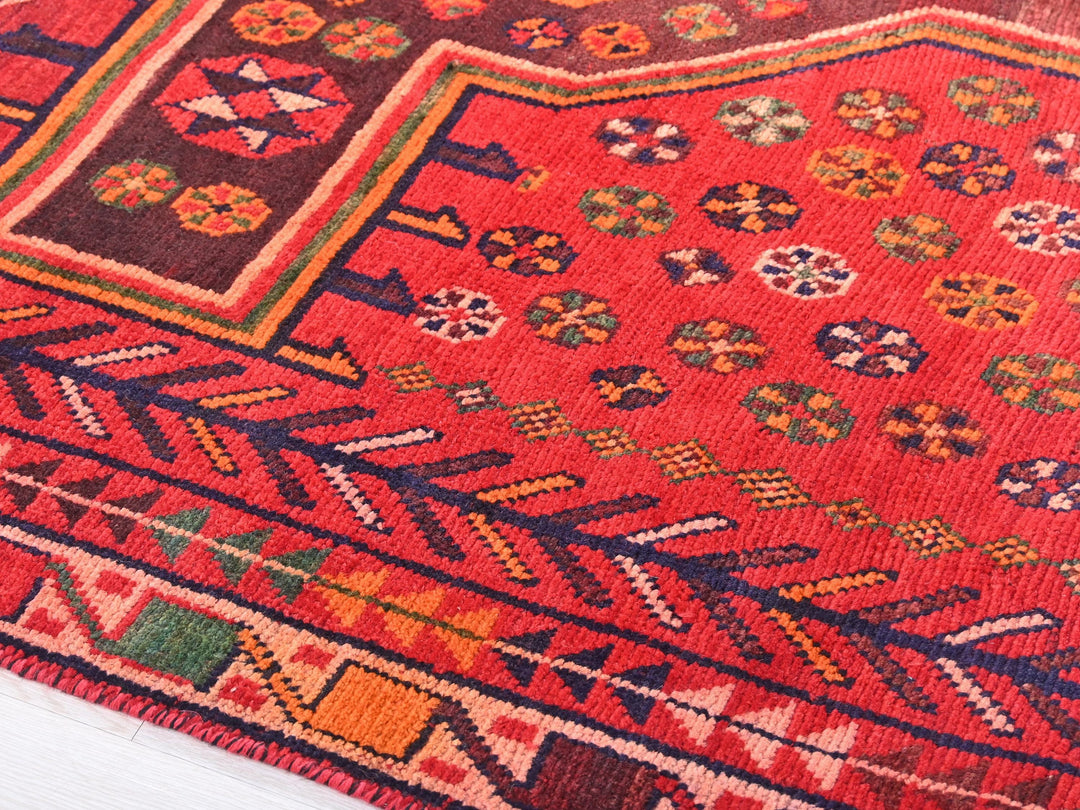 a red rug with a colorful design on it