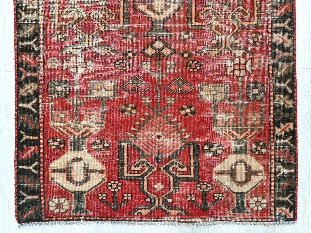 a red and black rug with a design on it