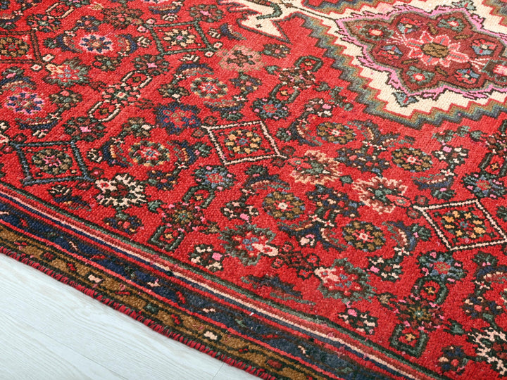 a red oriental rug on a white floor