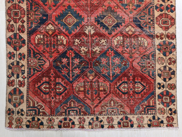 a red and blue rug with a diamond pattern