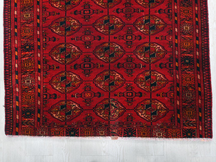 a red rug with a design on it