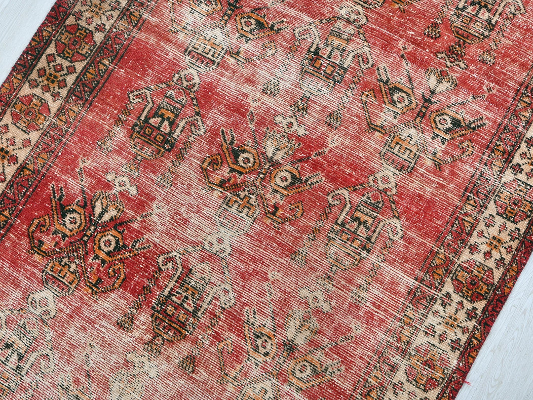 a red rug with a pattern on the middle of it