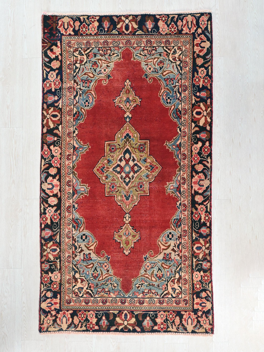 a red rug with an intricate design on it