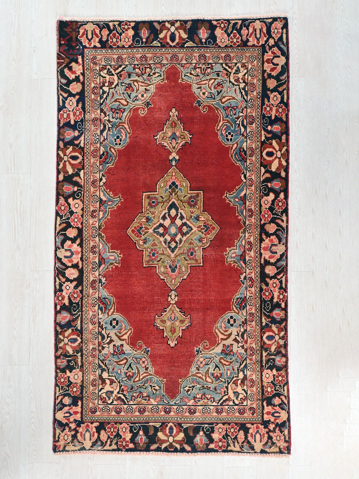 a red rug with an intricate design on it