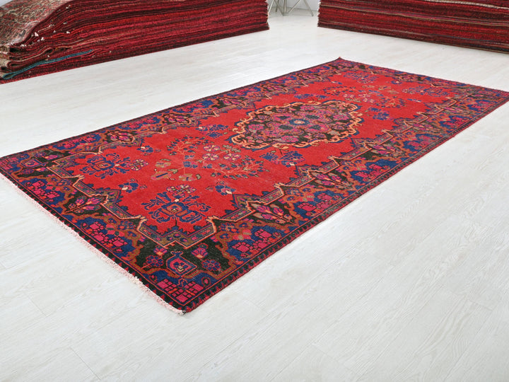 a red rug is laying on the floor