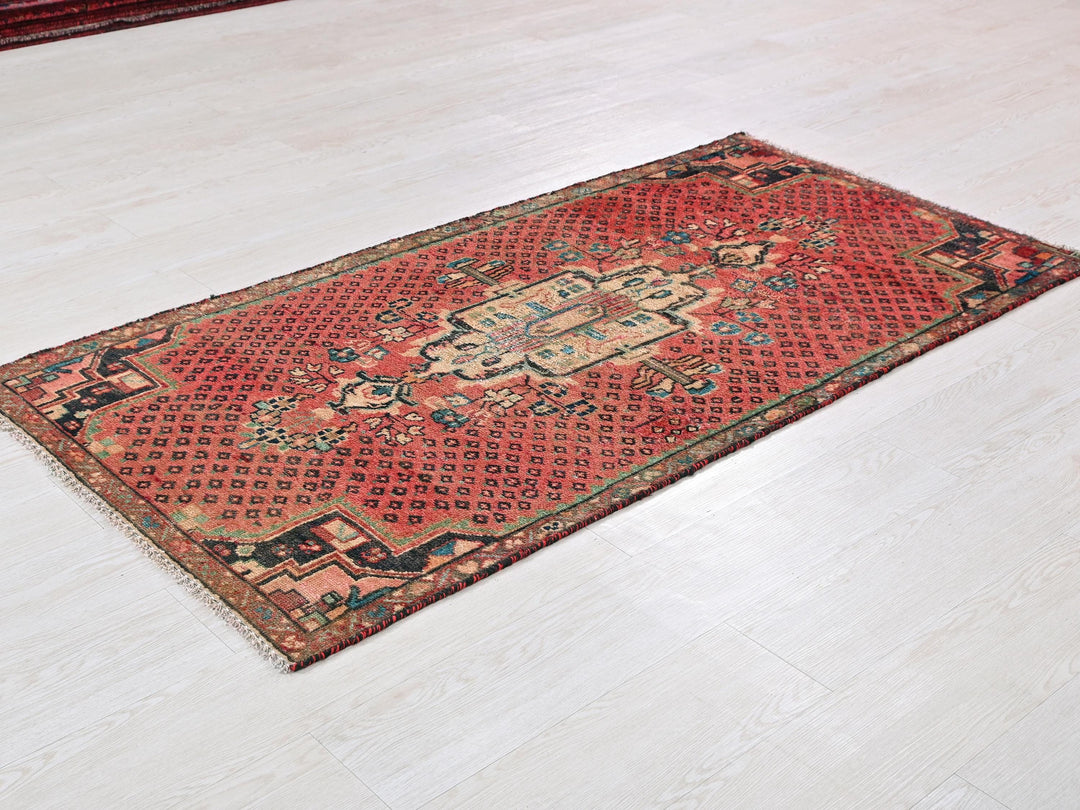 a red rug on a white floor in a room