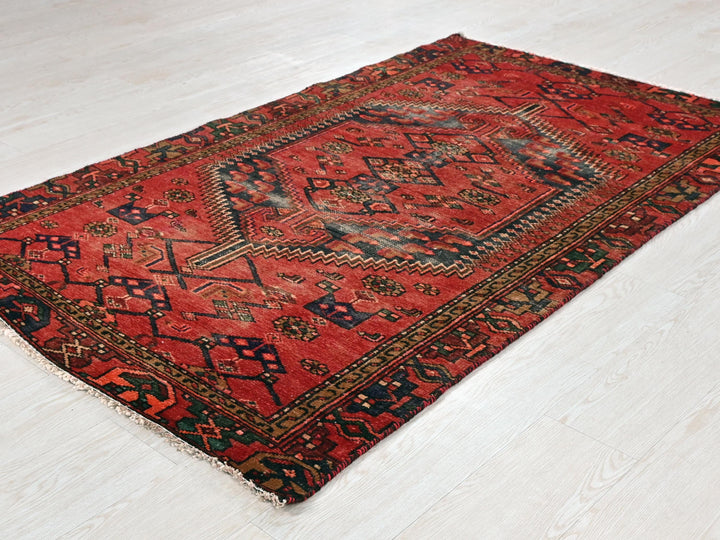 a red rug on the floor of a room