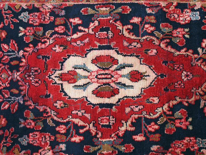 a red and blue rug with a floral design