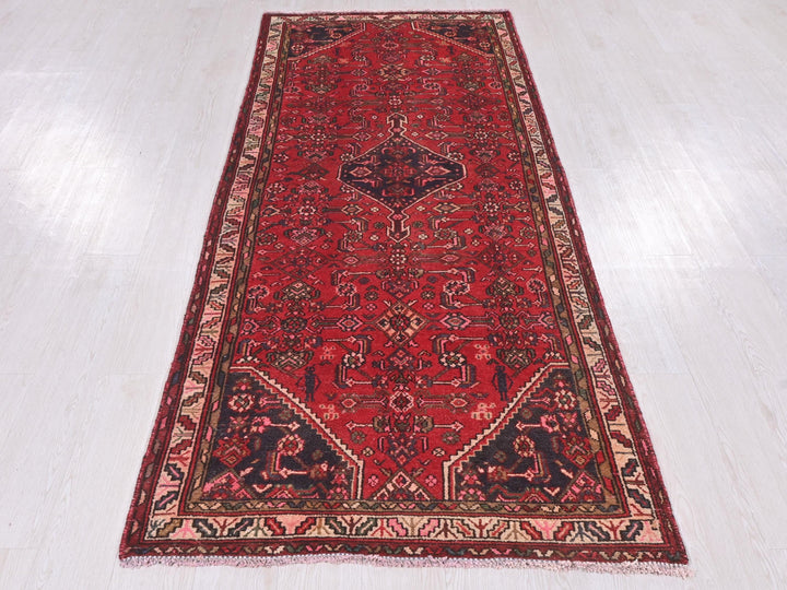 a long red rug on a white floor