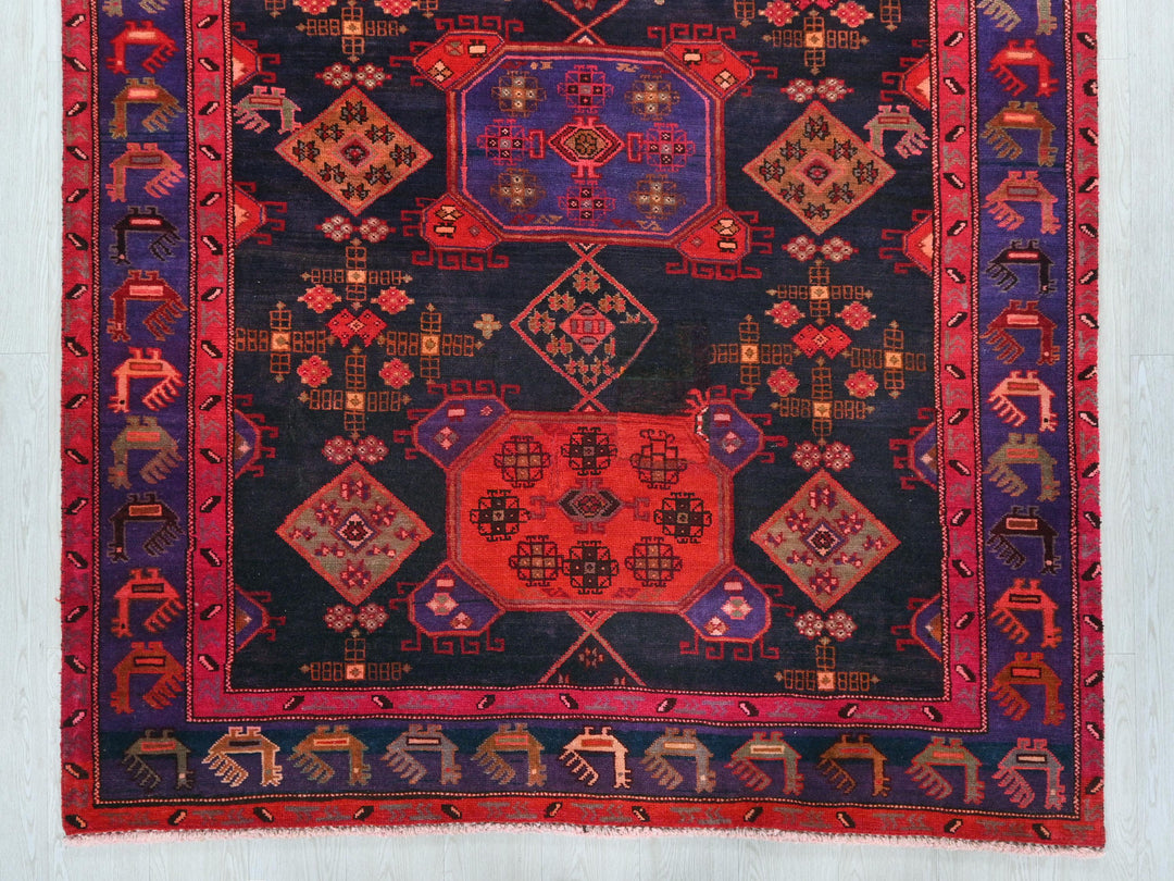 an oriental rug with a red center and a blue center