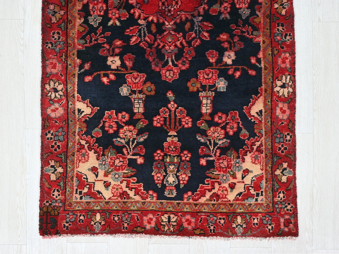 a red and blue rug with a floral design