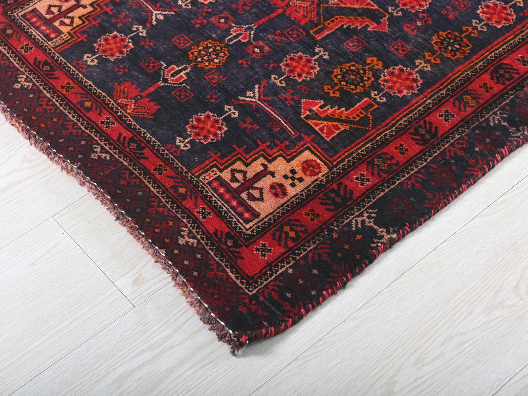 a red and blue rug on a white floor