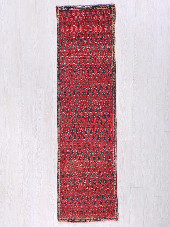 a red rug on a white wooden floor