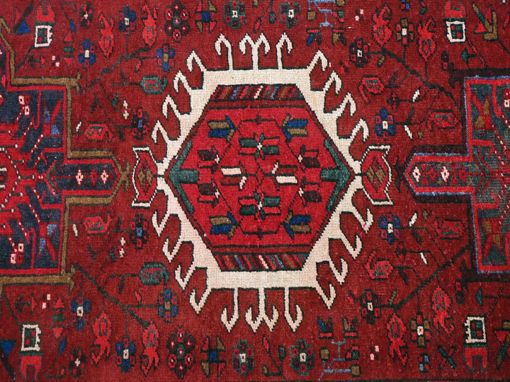 a red rug with a white center surrounded by smaller red and blue designs