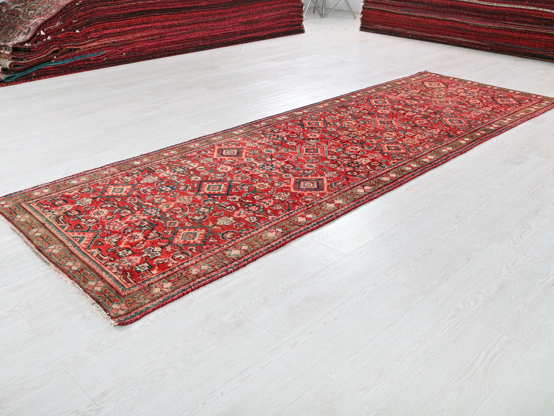 a red rug laying on a white floor