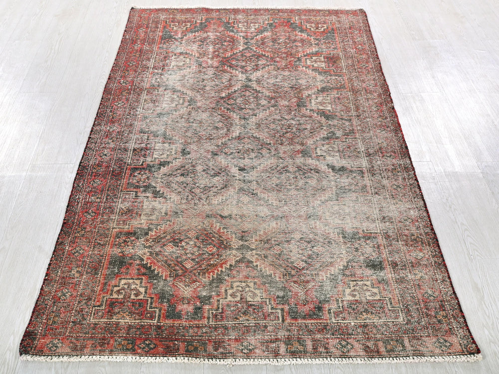a red and blue rug on a white floor